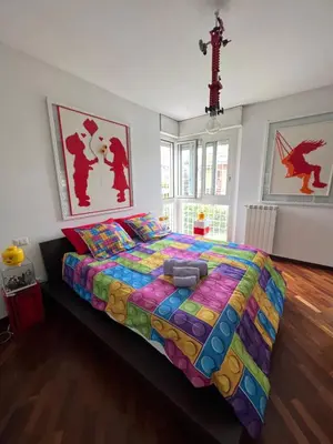 a bedroom with a large bed with a colorful comforter at Cip's Brickhouse in Rome