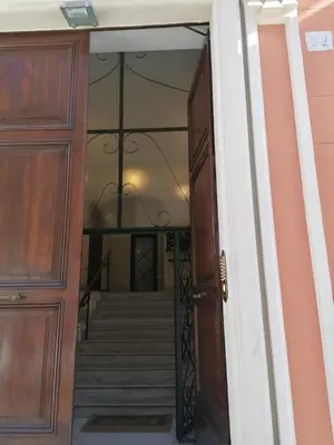 an open door leading to a stairway with a staircase at SCIPIO92HOME in Rome