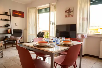 a dining room with a table and chairs at Casa Marta in Rome