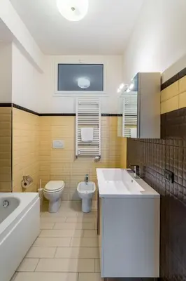 a bathroom with a tub and a toilet and a sink at Naima Apartment San Pietro in Rome