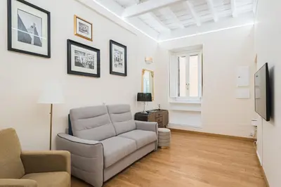 a living room with a couch and a tv at Lupa Luxury Apartment in Rome