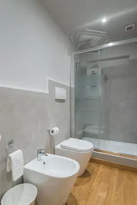 a bathroom with a toilet and a sink and a shower at Lupa Luxury Apartment in Rome