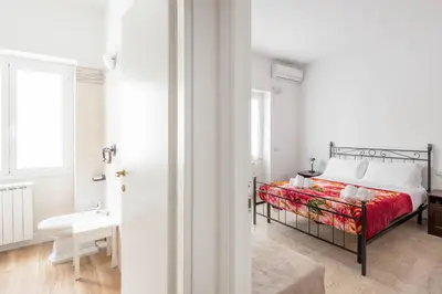 a bedroom with a bed and a sink and a window at Apartment Nonna Anna in Rome