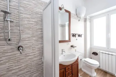 a bathroom with a sink and a toilet and a shower at Apartment Nonna Anna in Rome