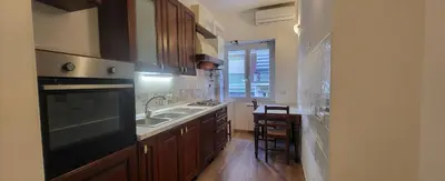a kitchen with a sink and a stove top oven at Apartment Nonna Anna in Rome