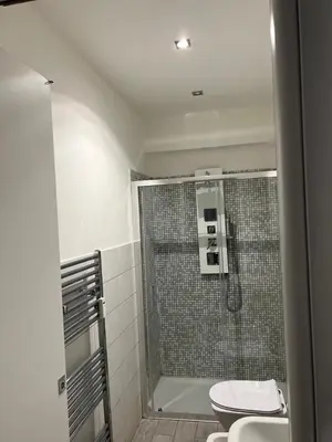 a bathroom with a shower with a toilet and a sink at Boutique Rooms in Rome