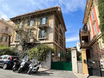 a couple of motorcycles parked in front of a building at Torlonia Rooms in Rome