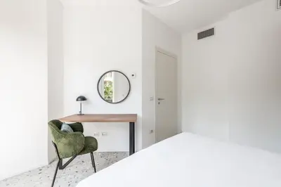 a bedroom with a desk and a chair at Numa Rome Verso in Rome