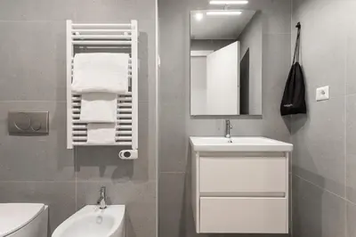a bathroom with a white sink and a mirror at Numa Rome Verso in Rome