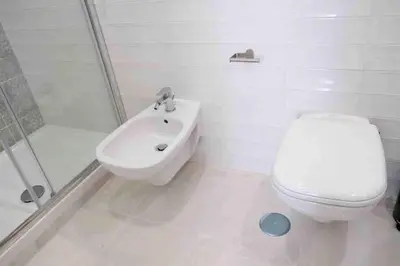 a bathroom with a toilet and a sink and a shower at COLOSSEUM LUXURY HOME in Rome