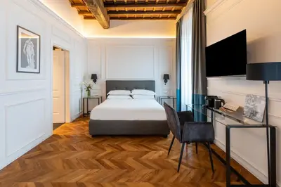 a hotel room with a bed and a desk at Largo Arenula Suites in Rome