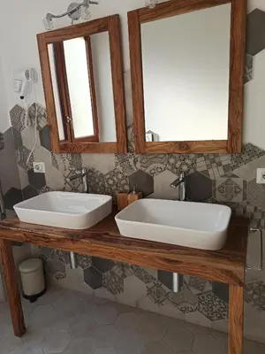 a bathroom with two sinks and two mirrors at B&B Suite and Rooms San Giovanni in Rome
