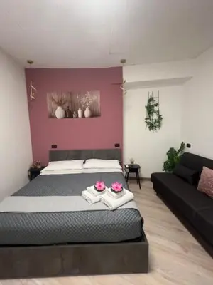 a bedroom with a large bed and a couch at Lungotevere Testaccio 6 Roma - Apartments in Rome