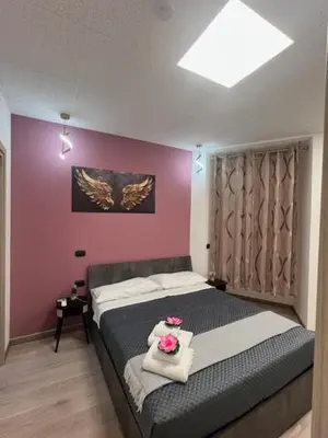 a bedroom with a bed with two roses on it at Lungotevere Testaccio 6 Roma - Apartments in Rome