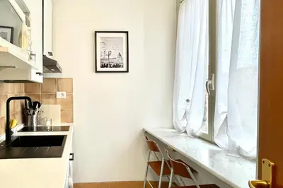 a kitchen with a counter and a sink and a window at Apt in front of the Vatican City in Rome