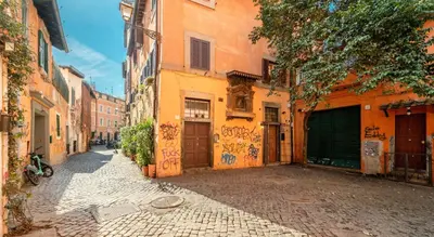an alley with graffiti on the side of a building at Old Trastevere Studio in Rome