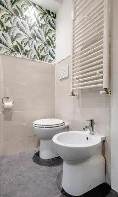 a bathroom with a toilet and a sink at Pantheon Caravaggio's House in Rome