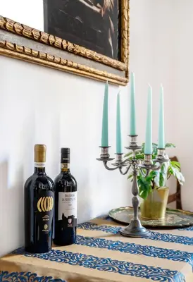 two bottles of wine sitting on a table with candles at Pantheon Caravaggio's House in Rome