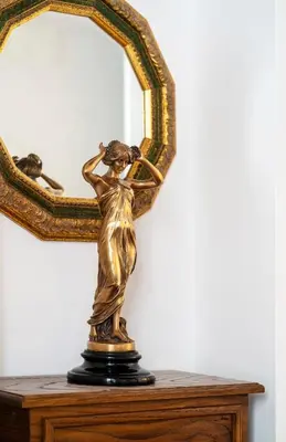 a bronze statue of a woman in front of a mirror at Pantheon Caravaggio's House in Rome