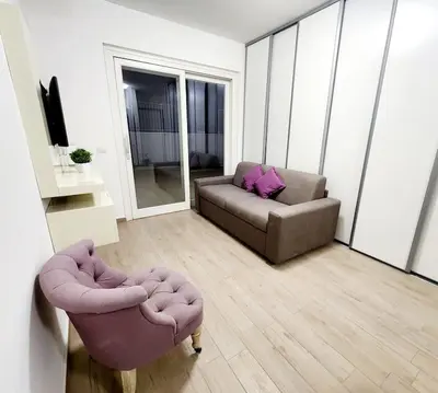 a living room with a couch and a chair at Quela Apartment - Pietralata in Rome
