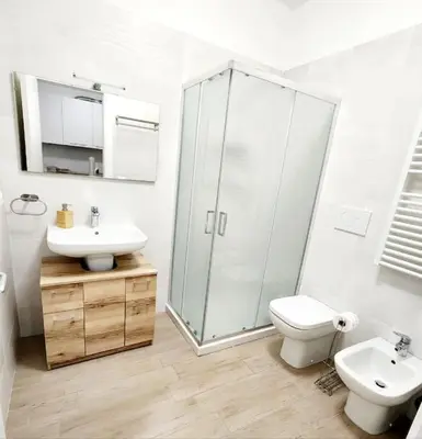 a bathroom with a shower and a toilet and a sink at Quela Apartment - Pietralata in Rome