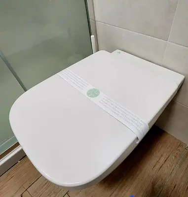 a white toilet in a bathroom with a toilet seat at Quela Apartment - Pietralata in Rome