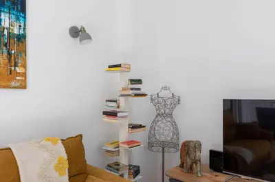 a living room with a shelf with a dress on it at iFlat Shiny Loft in Trastevere in Rome