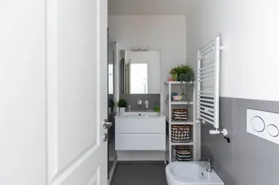 a bathroom with a sink and a toilet and a mirror at iFlat Shiny Loft in Trastevere in Rome