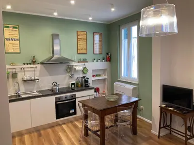 a kitchen with a table and a dining room at Casa MANÍ Campo de Fiori in Rome