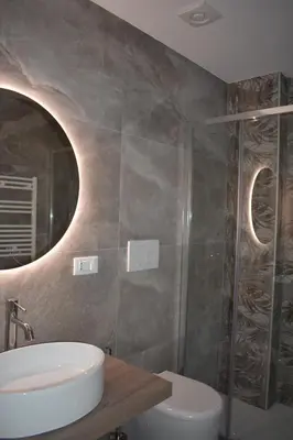 a bathroom with a sink and a toilet and a mirror at Gallery House 59 Guest House in Rome