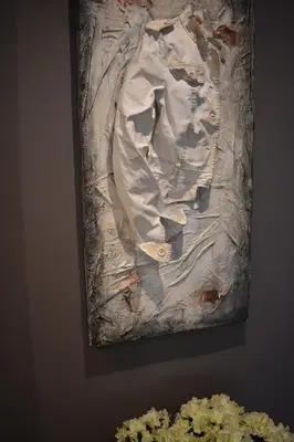 a painting hanging on a wall next to flowers at Gallery House 59 Guest House in Rome