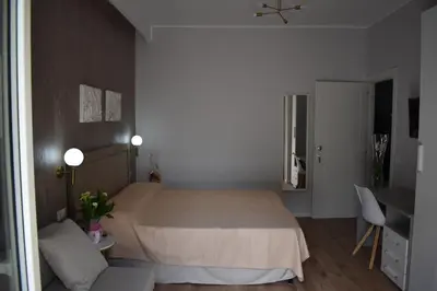 a bedroom with a bed and a table and a desk at Gallery House 59 Guest House in Rome