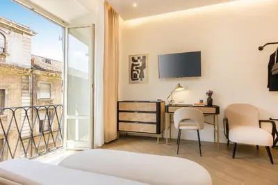 a bedroom with a desk and chairs and a tv at Colosseum Boutique Apartment in Rome