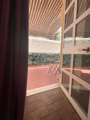 an open door to a patio with a table at Tolemaide Boutique Apartment in Rome