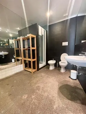 a bathroom with two toilets and a sink at Tolemaide Boutique Apartment in Rome