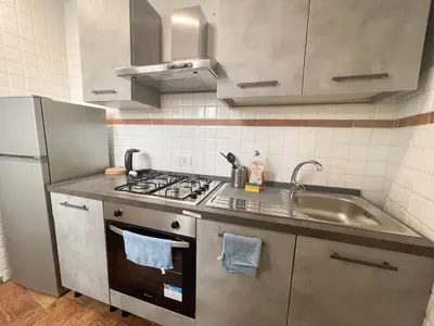 a kitchen with a sink and a stove top oven at Tolemaide Boutique Apartment in Rome