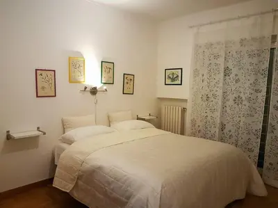 a bedroom with a large white bed and a window at Minohouse Vatican view in Rome