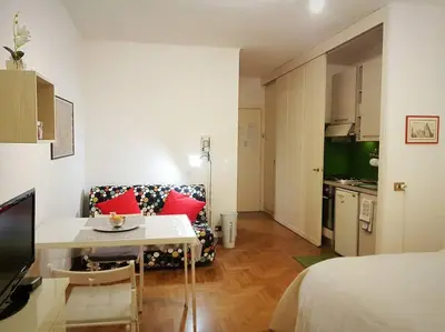 a living room with a couch and a table in a room at Minohouse Vatican view in Rome