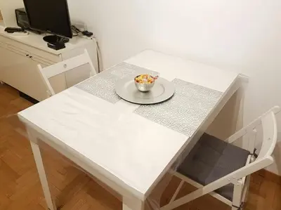 a white table with a bowl of candy on it at Minohouse Vatican view in Rome
