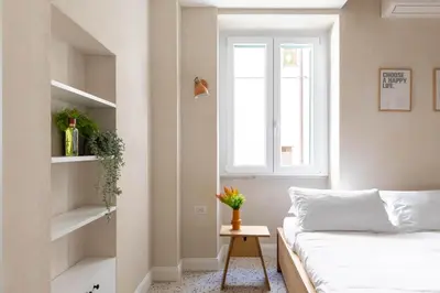 a small bedroom with a bed and a window at iFlat Lovely Flat in Trastevere in Rome