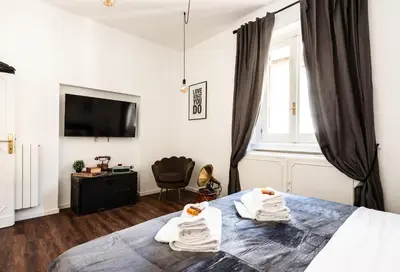 a bedroom with a bed with towels on it at Piacentino Homes Corso apartment in Rome