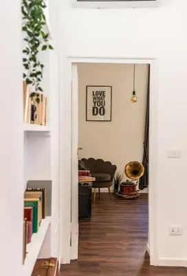 a hallway with a living room with a couch at Piacentino Homes Corso apartment in Rome