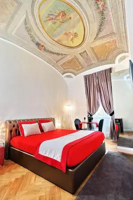 a bedroom with a large bed with a painting on the ceiling at AMM Luxury Rooms in Rome