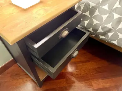 a wooden table with two drawers on top of a bed at Inn Sistina Home in Rome