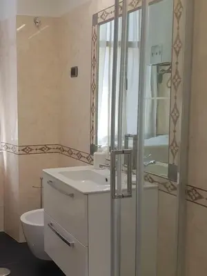 a bathroom with a sink and a toilet and a mirror at Holiday Apartment Rome LR Blue in Rome