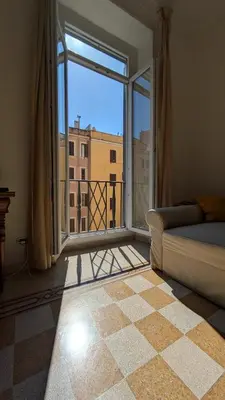 a living room with a couch and a large window at Holiday Apartment Rome LR Blue in Rome