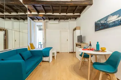 a living room with a blue couch and a table at Lovely Nest by the Pantheon in Rome