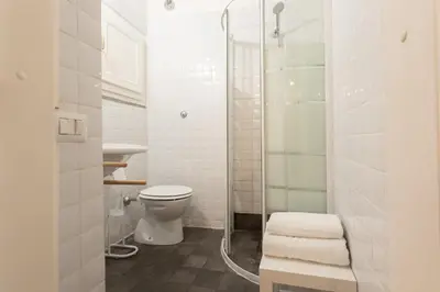 a bathroom with a toilet and a glass shower at Lovely Nest by the Pantheon in Rome