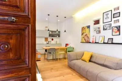 a living room with a couch and a table at Paolina Boutique Apartment Monti in Rome