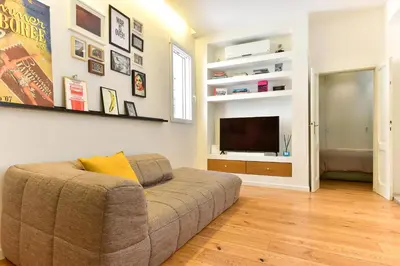 a living room with a couch and a flat screen tv at Paolina Boutique Apartment Monti in Rome